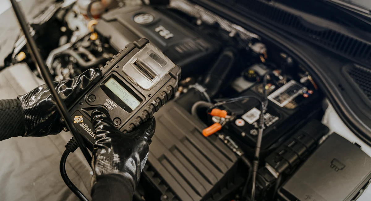 Diagnostic tool checking an engine during automotive service