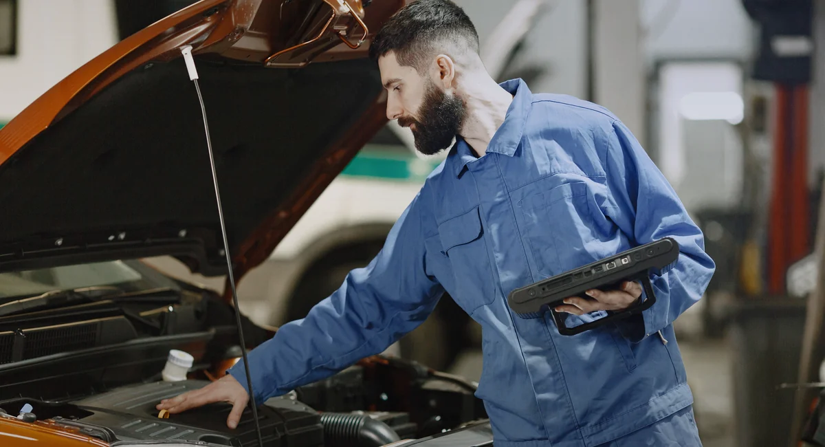 Mechanic inspecting an engine during maintenance service