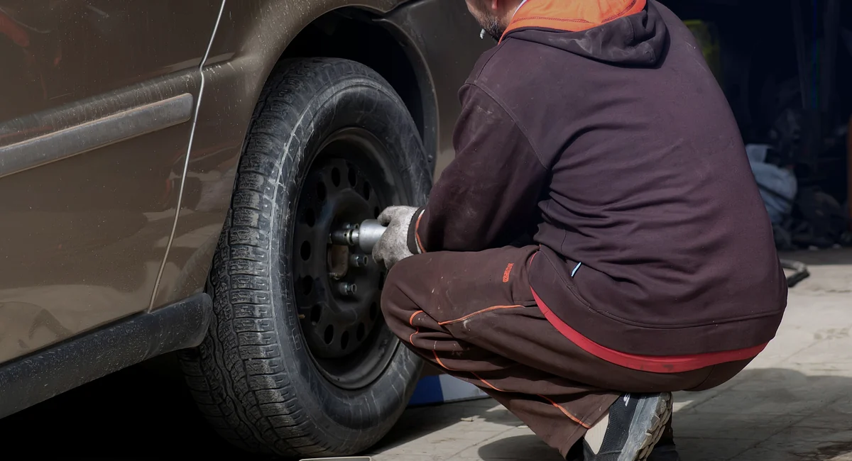 Mechanic working on a vehicle tire during tire service